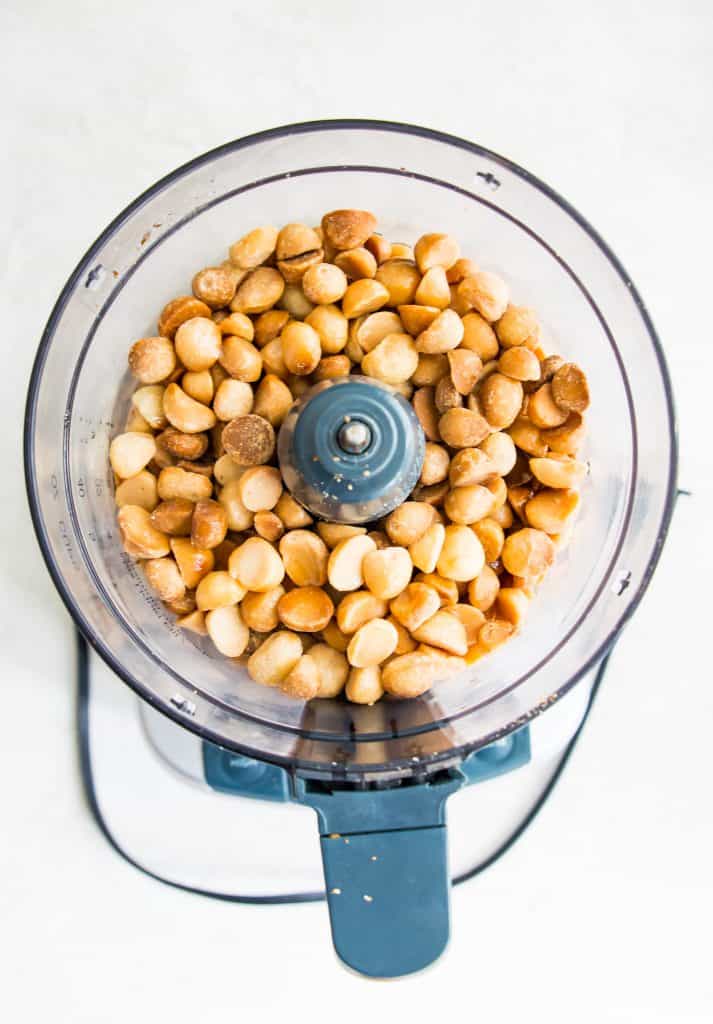 Roasted macadamia nuts in a food processor.