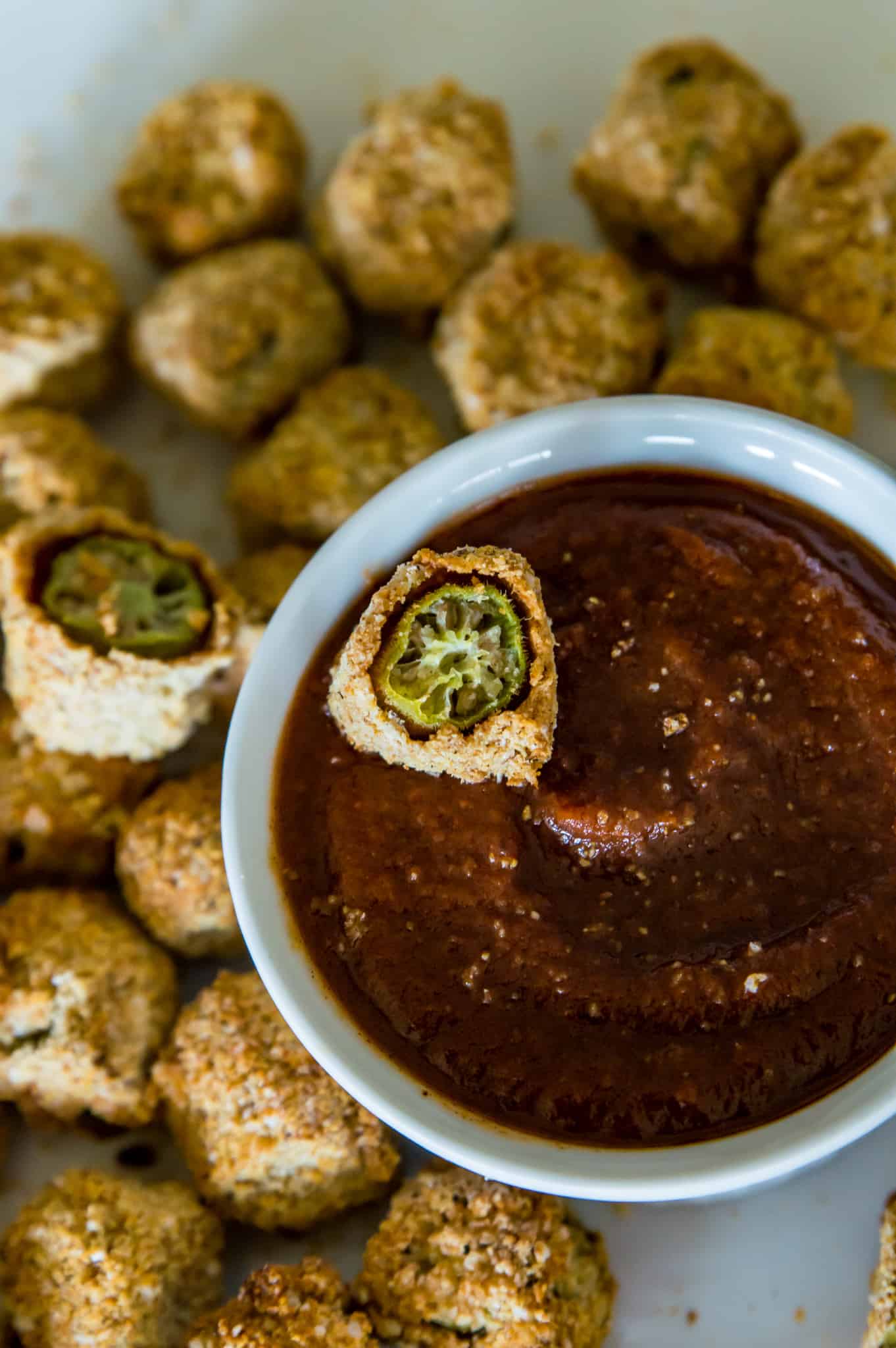 Fried Okra with a breaded coating on a plate with bbq sauce
