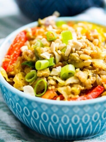 A bowl of healthy egg roll in a bowl garnished with green onion.