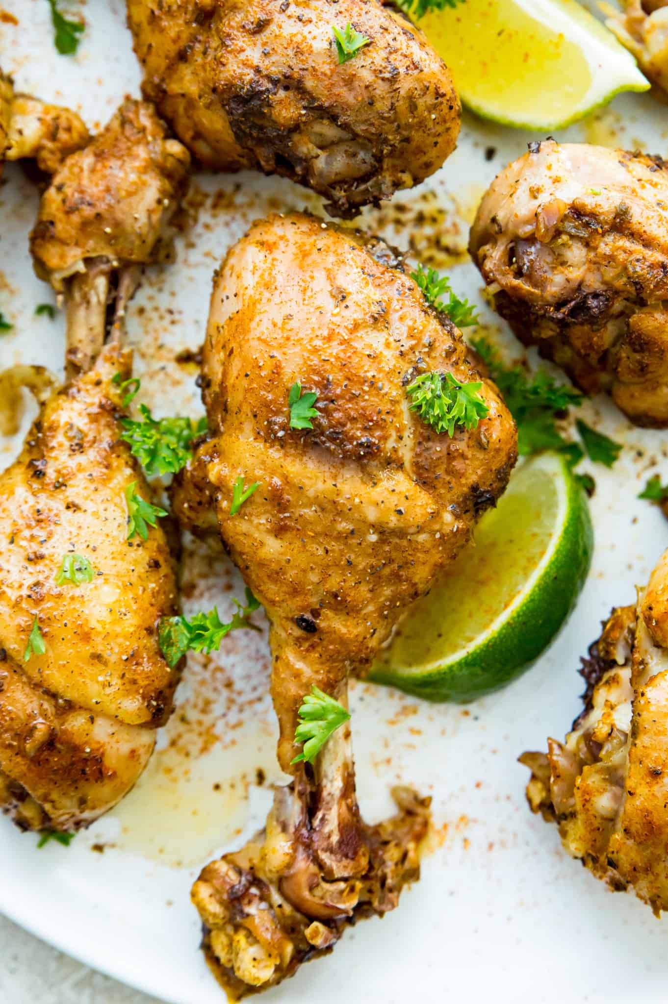A plate of chicken drumsticks that were cooked in an Instant pot garnished with cilantro.