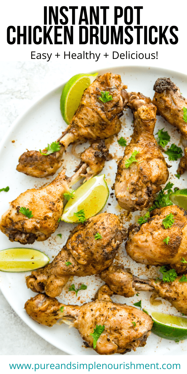 A plate of chicken drumsticks with lime wedges