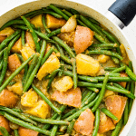 Cooked green beans and potatoes in a pan