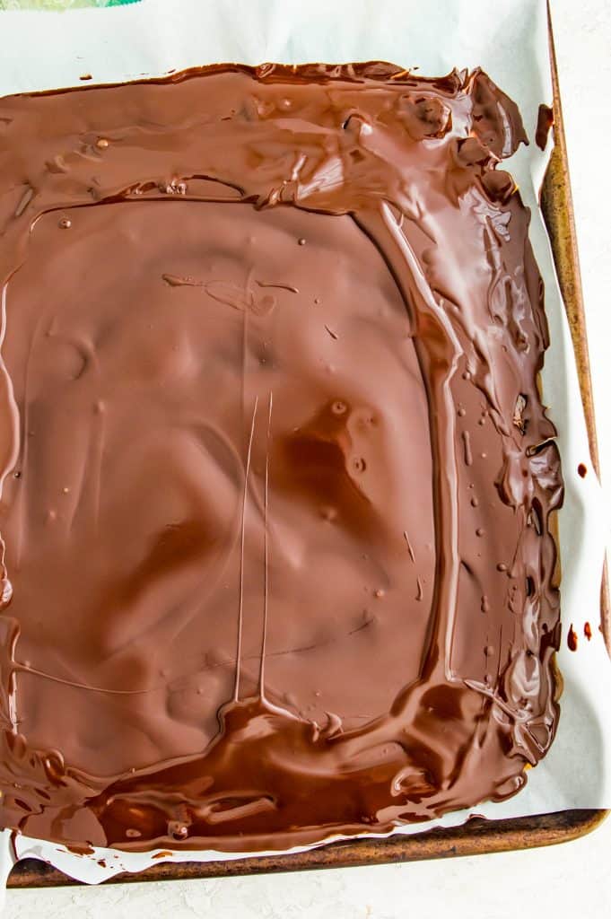 A baking sheet with chocolate poured on it.