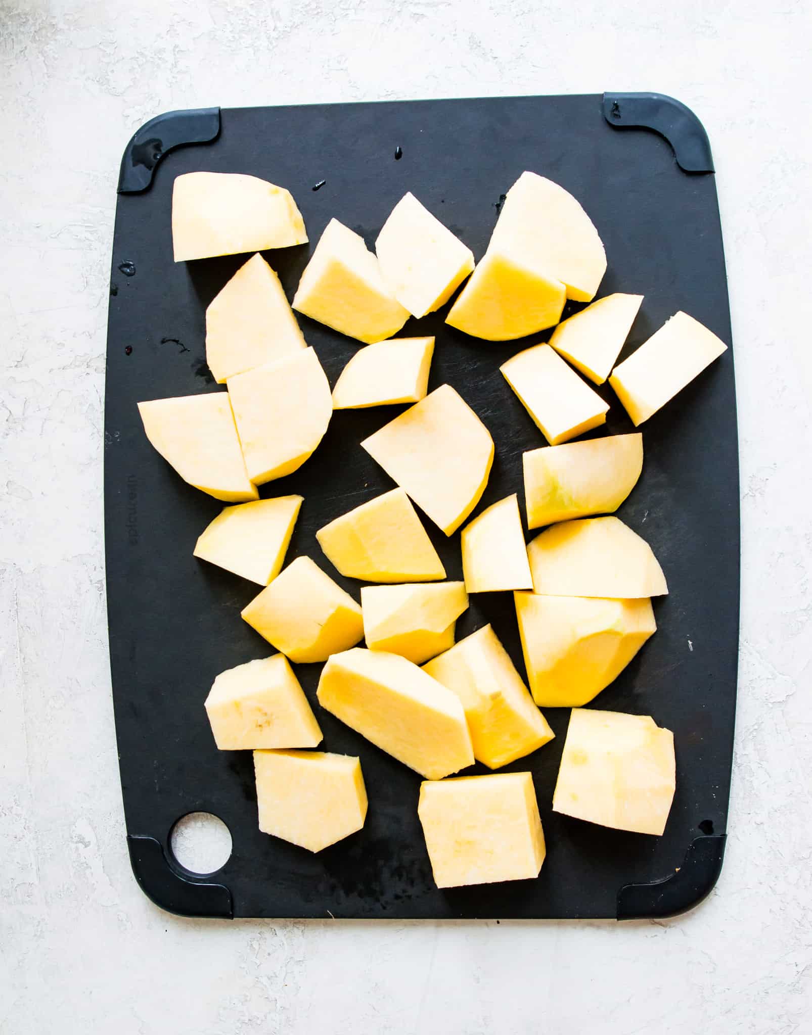 Peeled and chopped turnips on a cutting board.