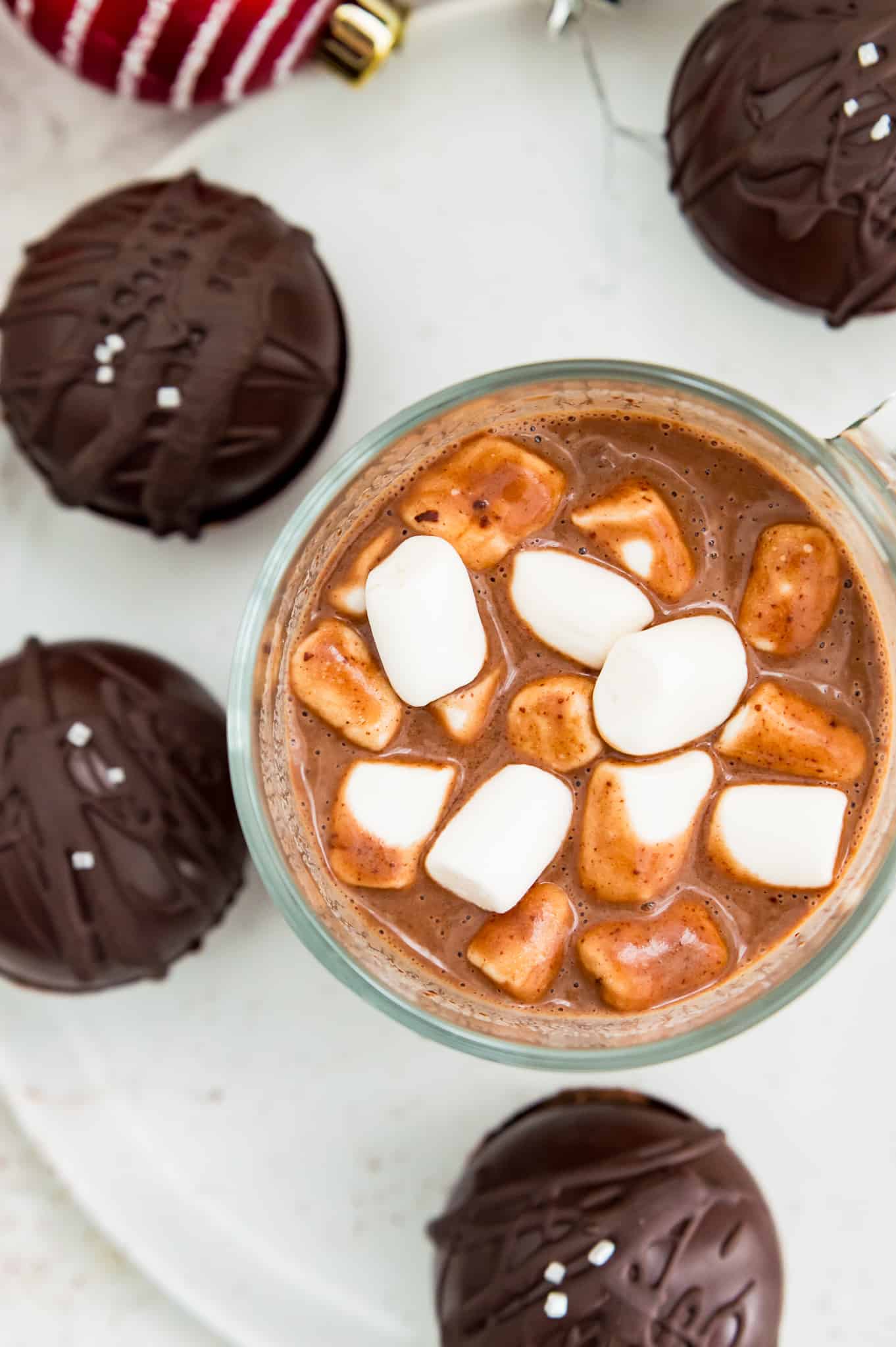 A mug of hot chocolate made from a vegan hot chocolate bomb and topped with marshmallows