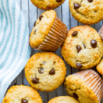 A rack full of banana protein muffins topped with chocolate chips