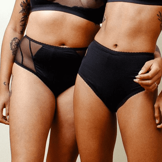 Two women wearing black Revol underwear.