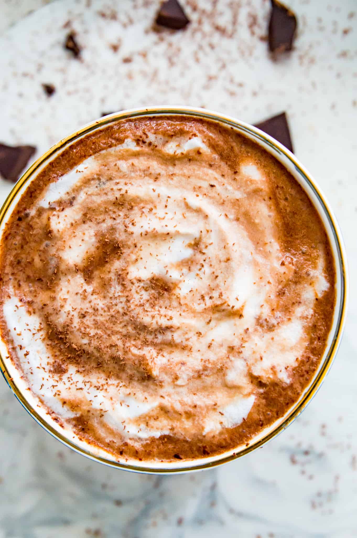 vegan hot chocolate A mug full of vegan hot chocolate topped with shaved dark chocolate.