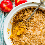 A dish of turnip and apple casserole with a spoon in it