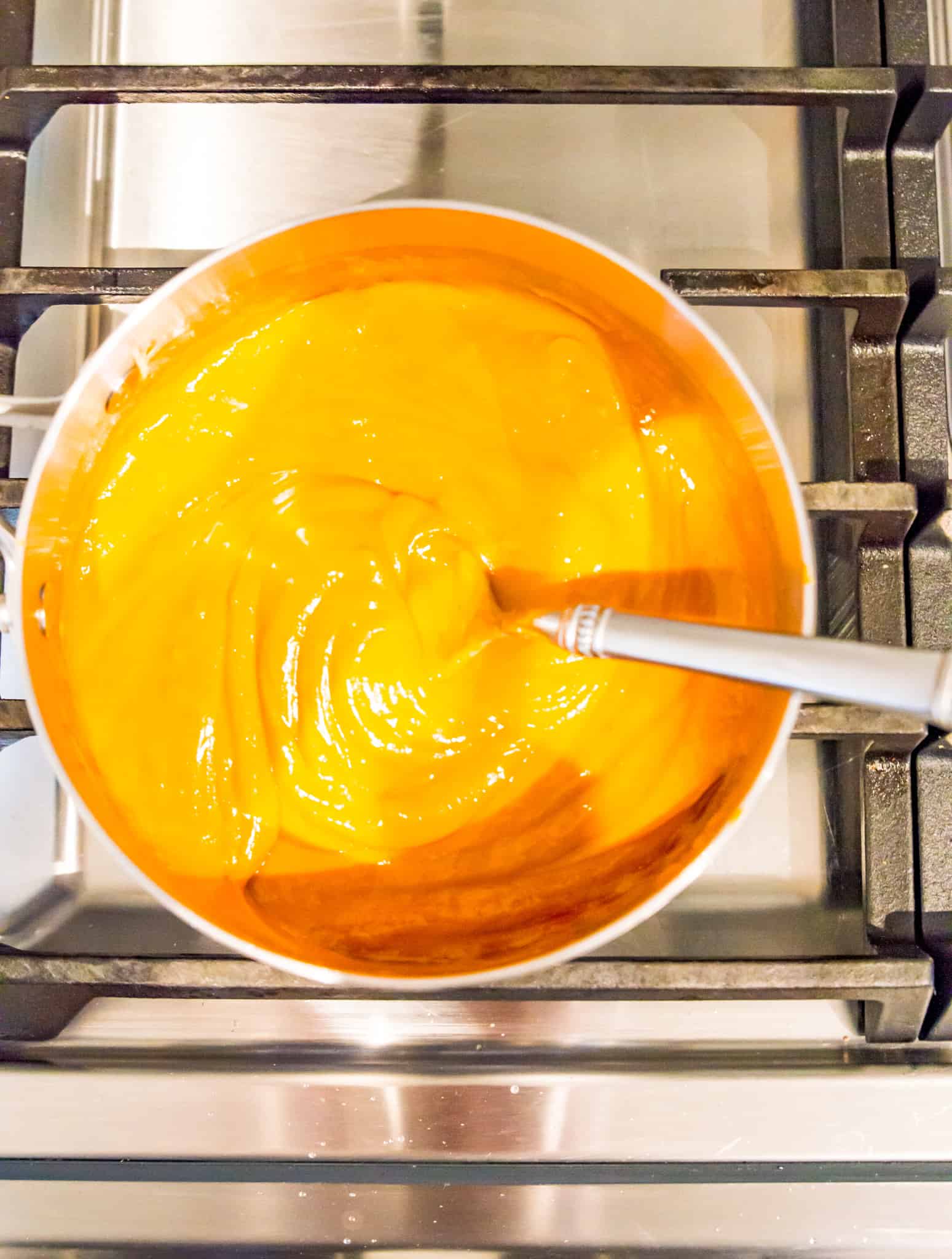 A pot with vegan buffalo sauce being made in it. 