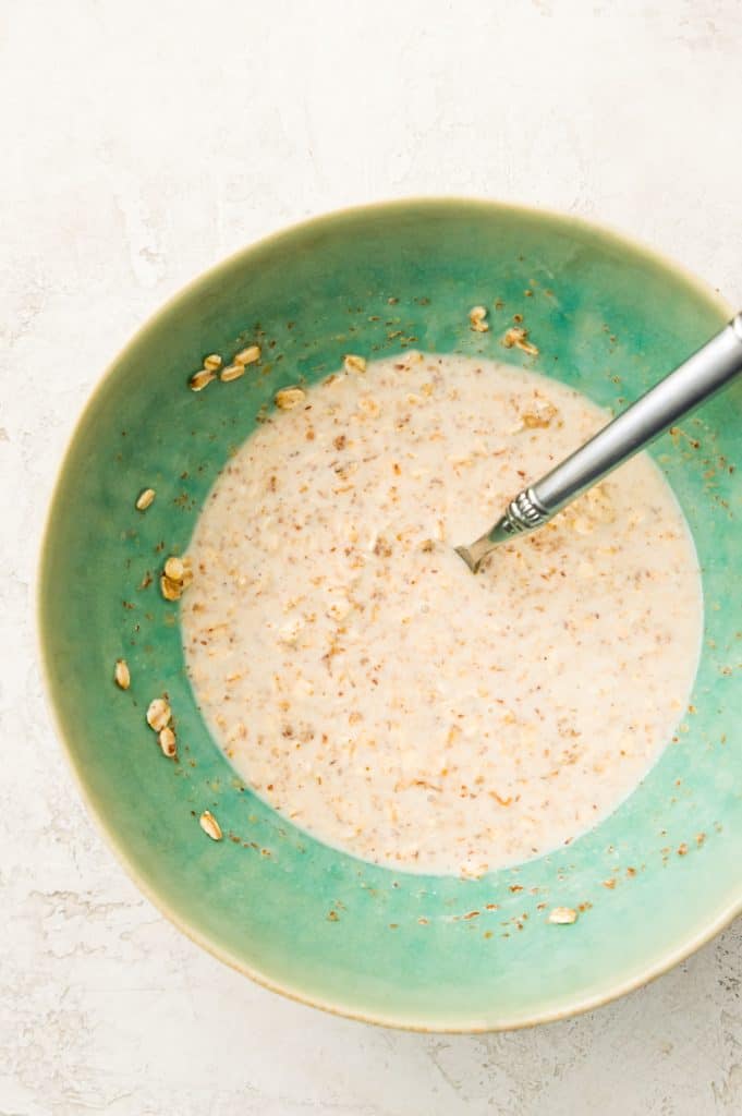A large bowl full of protein overnight oats with a spoon in it.
