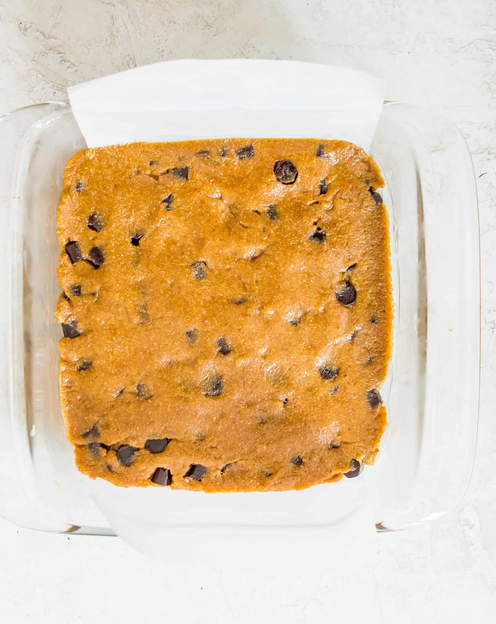 A baking pan with blondie dough in it.