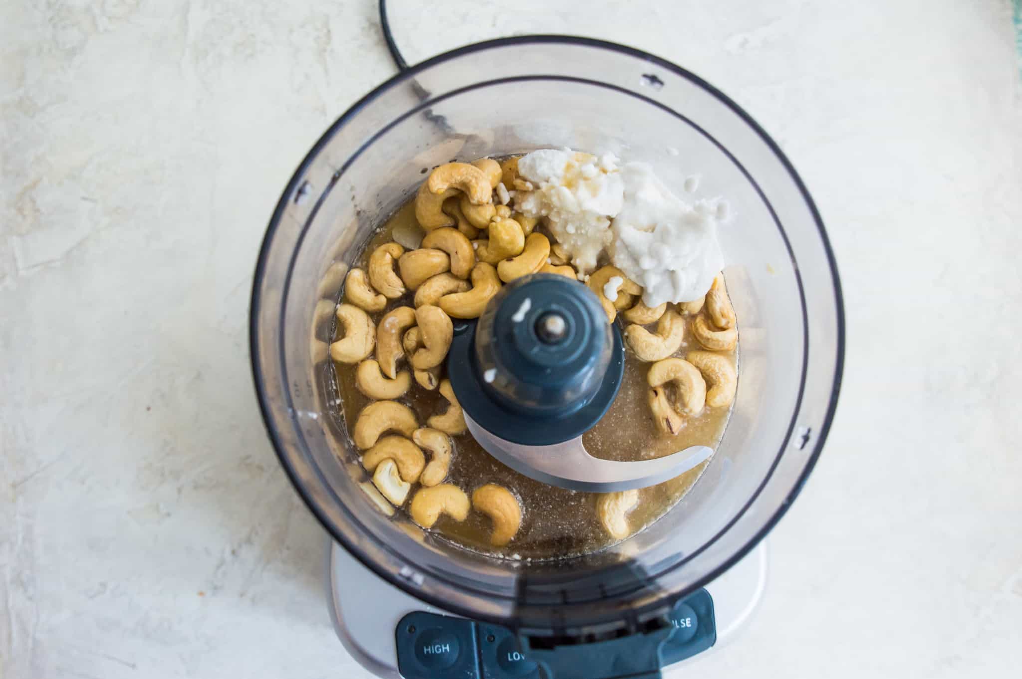 Cashews and coconut milk in a food processor.