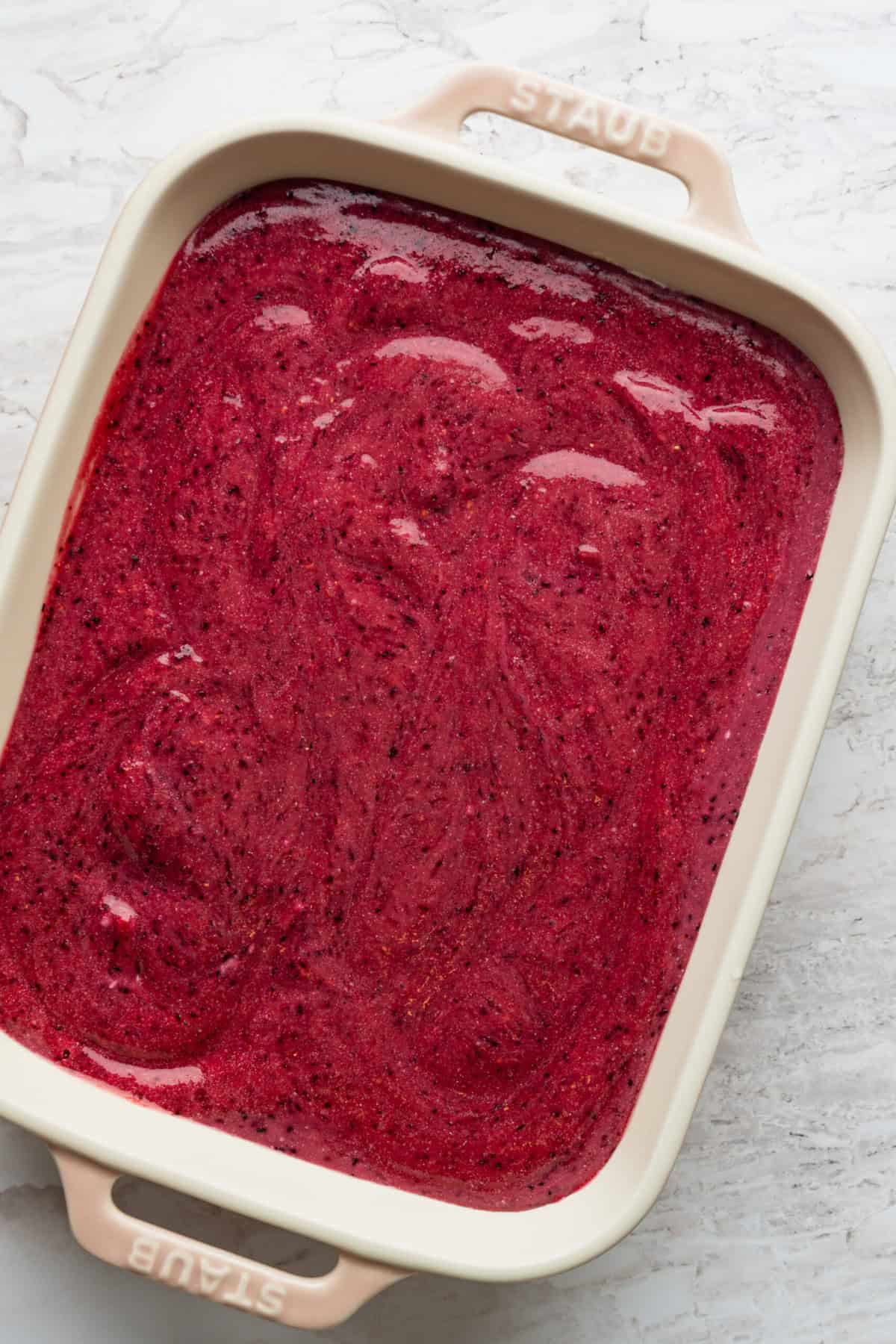 A pan with a red mixture in it.