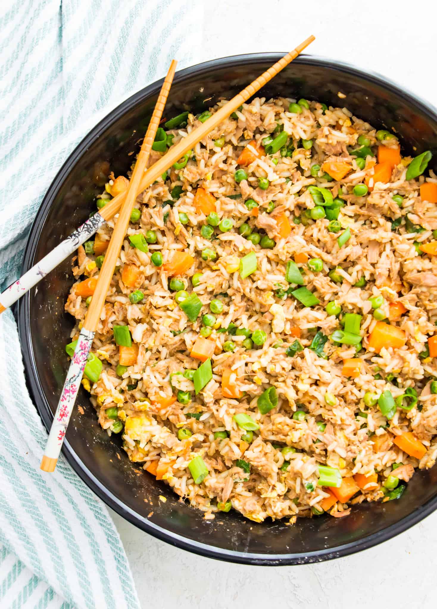 A pan of tuna fried rice with chopsticks on top of it.