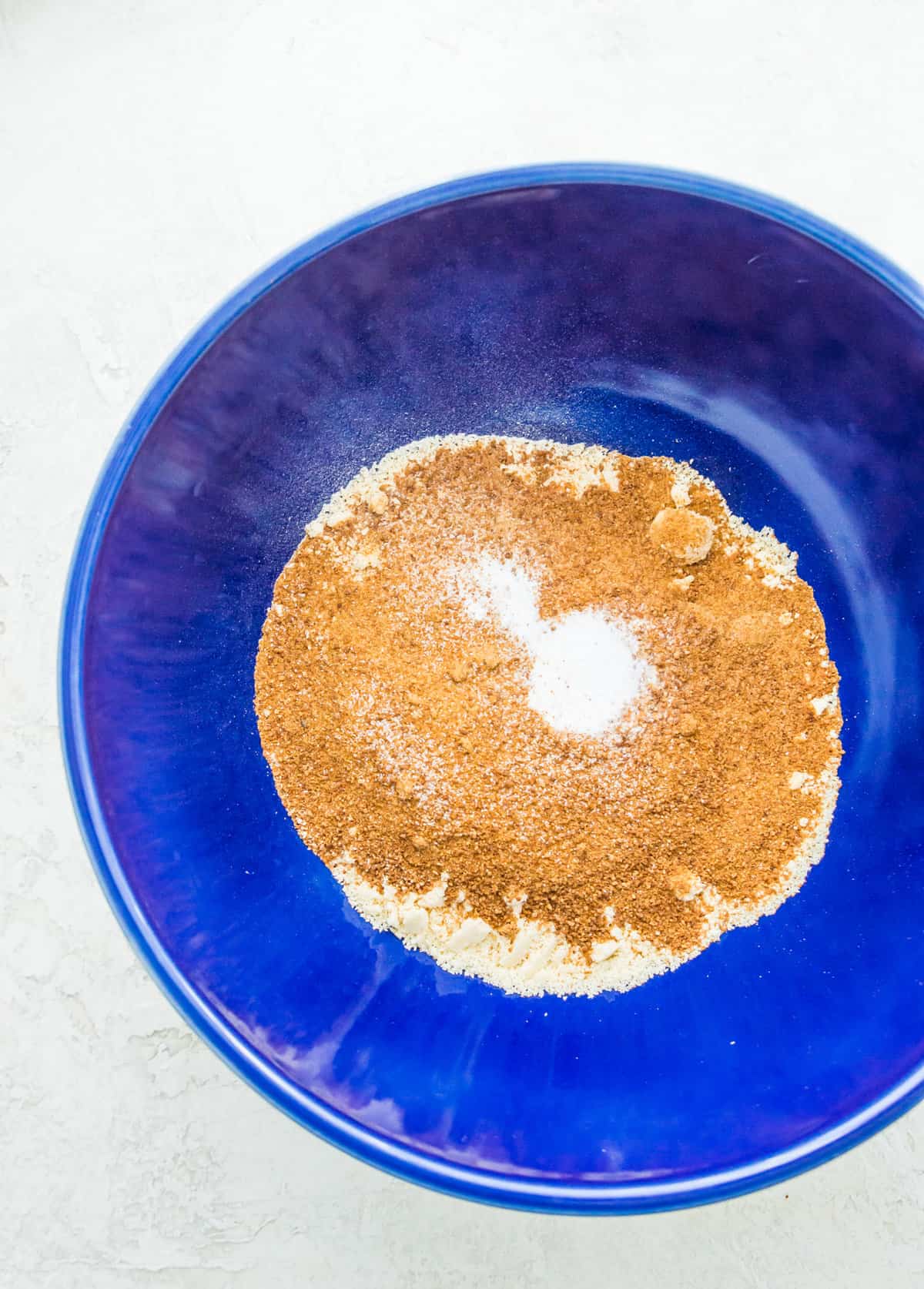 A bowl with almond flour, coconut sugar and baking soda in it.