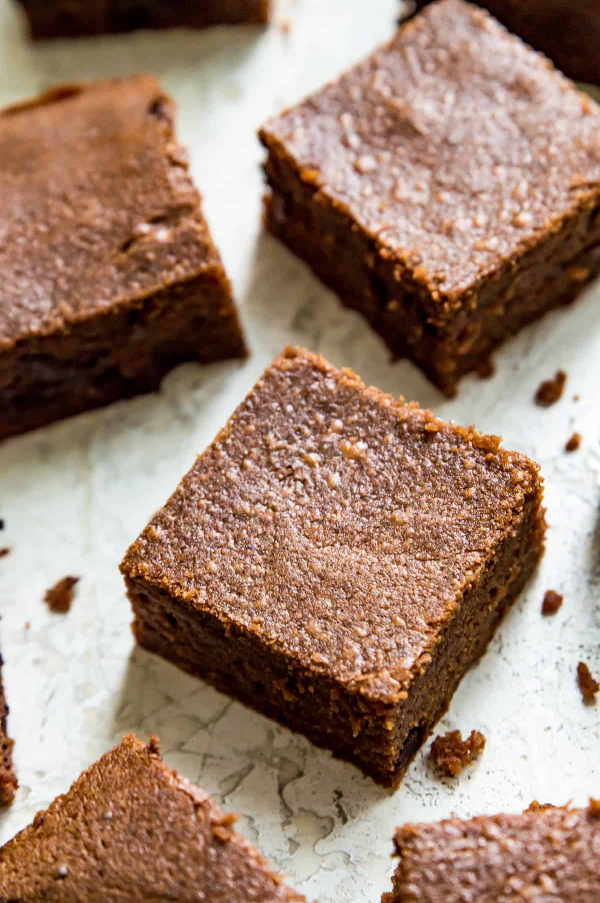 Condensed milk brownies cut into pieces on a serving tray.