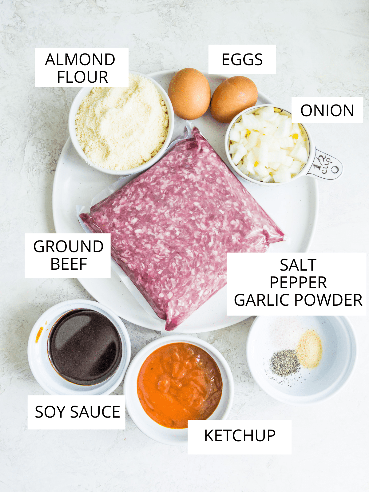 The ingredients needed for making gluten free burgers in small bowls and plates.