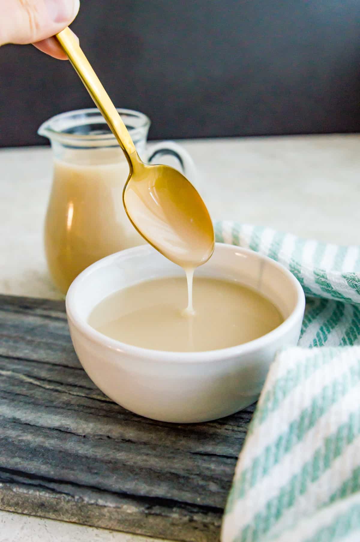 A bowl of coconut condensed milk with a spoon in it.