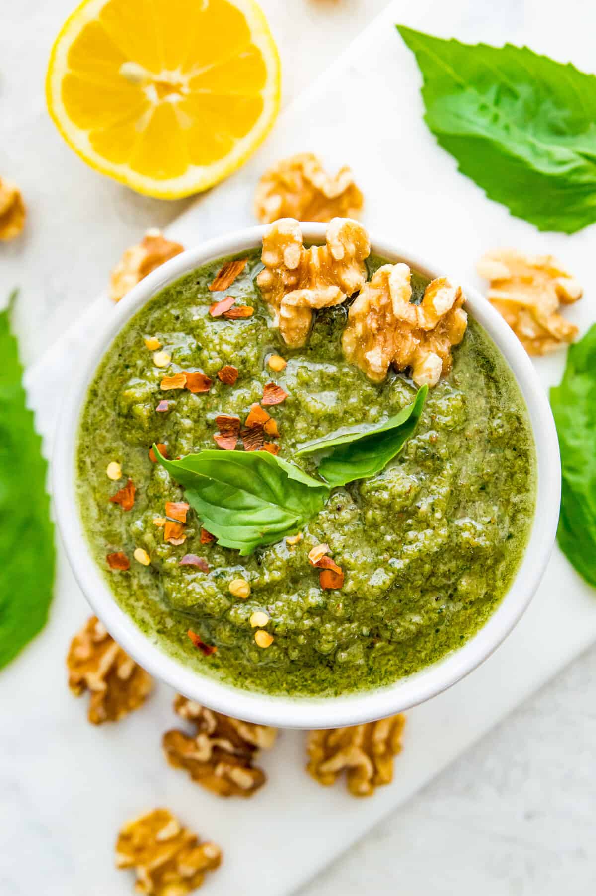 A bowl of vegan walnut pesto topped with walnuts.