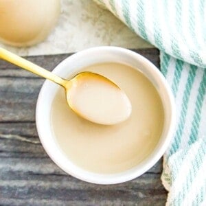 A bowl of coconut condensed milk with a spoon in it.