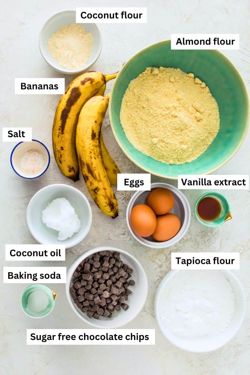 Ingredients for making banana bread separated into bowls including flour, bananas, eggs, coconut oil and baking soda.
