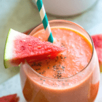 a watermelon banana smoothie in a glass with a straw in it