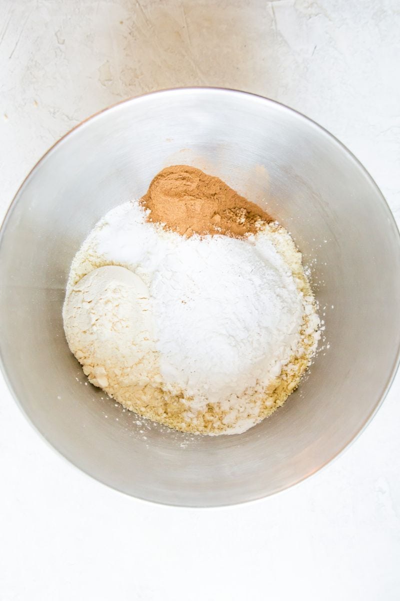 A mixing bowl filled with flour, ground cinnamon and sugar.