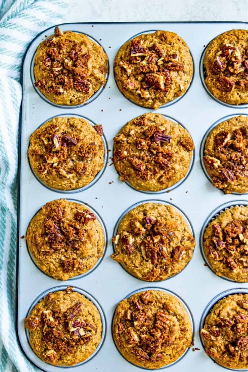 A muffin pan filled with baked pecan muffins. 