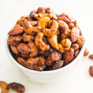 A bowl of curry cashews and almonds.