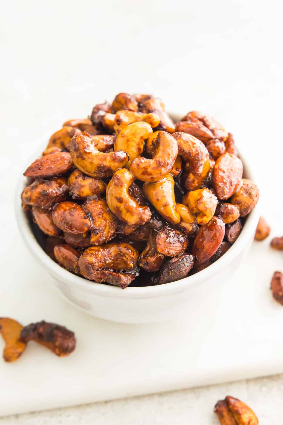 A bowl of curried cashews and almonds. 
