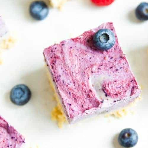 A berry ice cream bar topped with a fresh blueberry. 