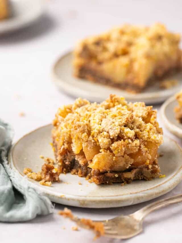 A healthy apple bar on a plate with a bite out of it.