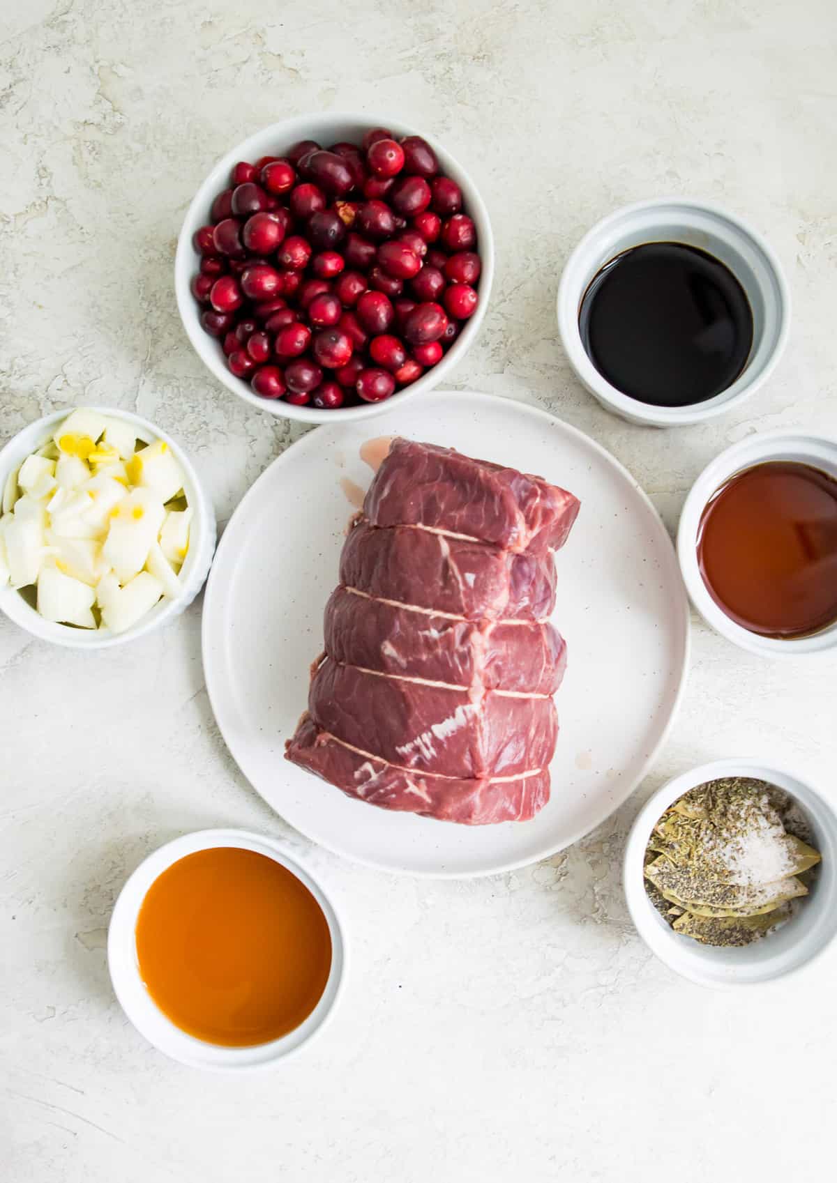 The ingredients needed to make a slow cooker beef roast, separated into bowls. 