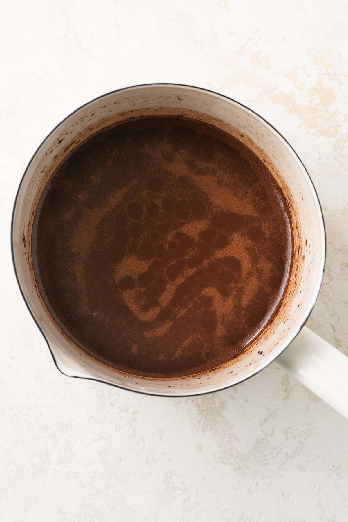 A pot with melted chocolate in it.