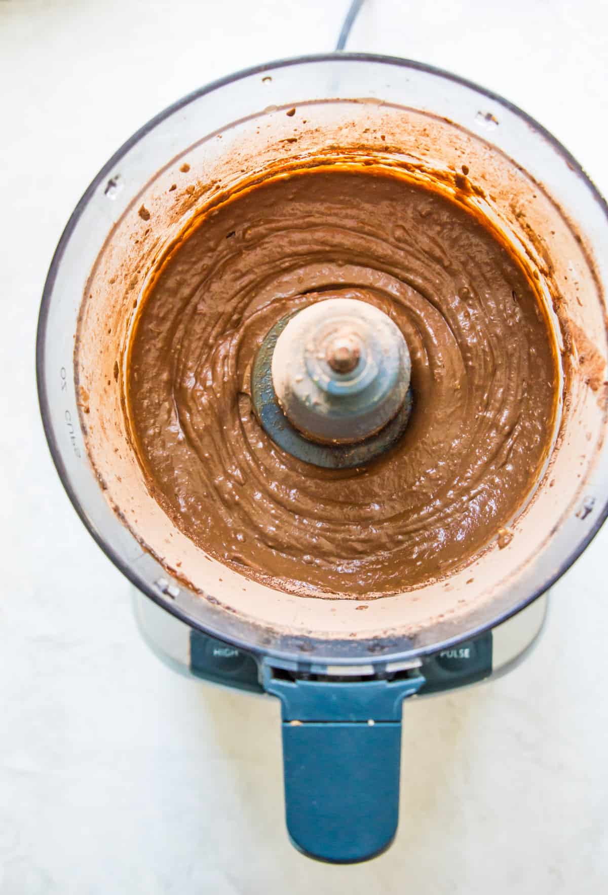 A blended chocolate avocado mousse in a food processor.