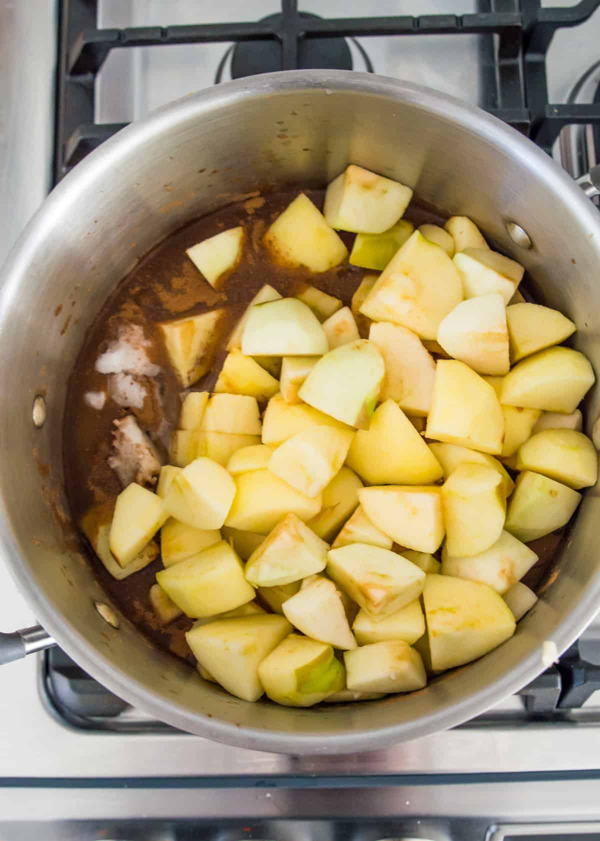 Chopped apples in a large pot on the stovetop. 