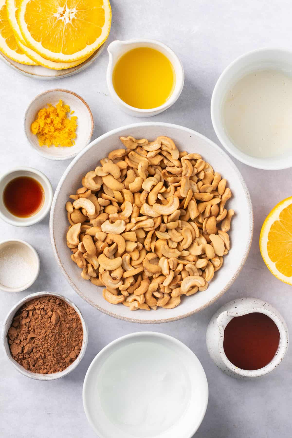 The ingredients needed to make vegan orange chocolate fudge, separated into bowls. 