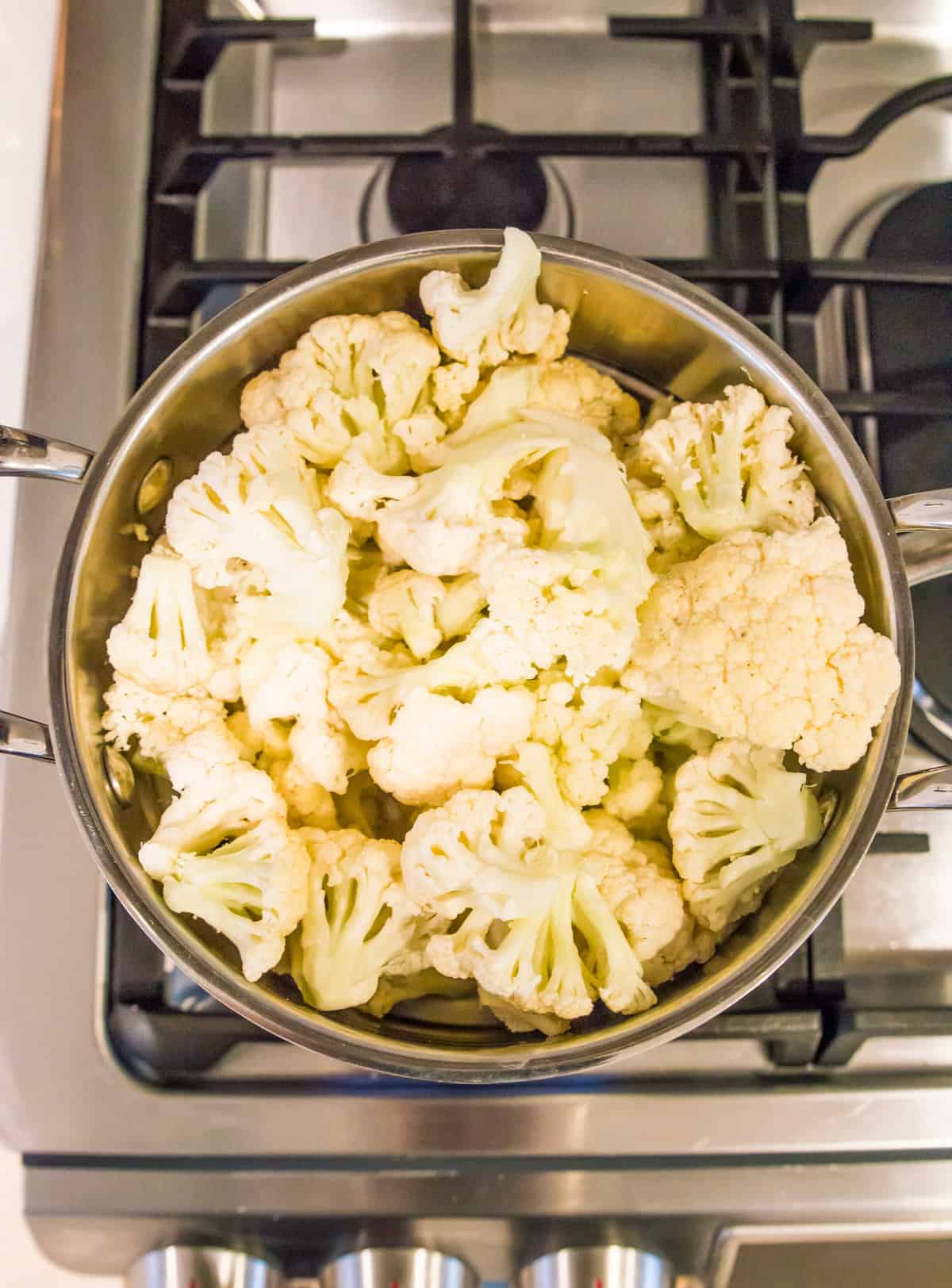 A pot of cauliflower florets on the stovetop.