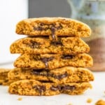 A stack of chocolate filled cookies with bites out of each one so you can see the chocolate filling.