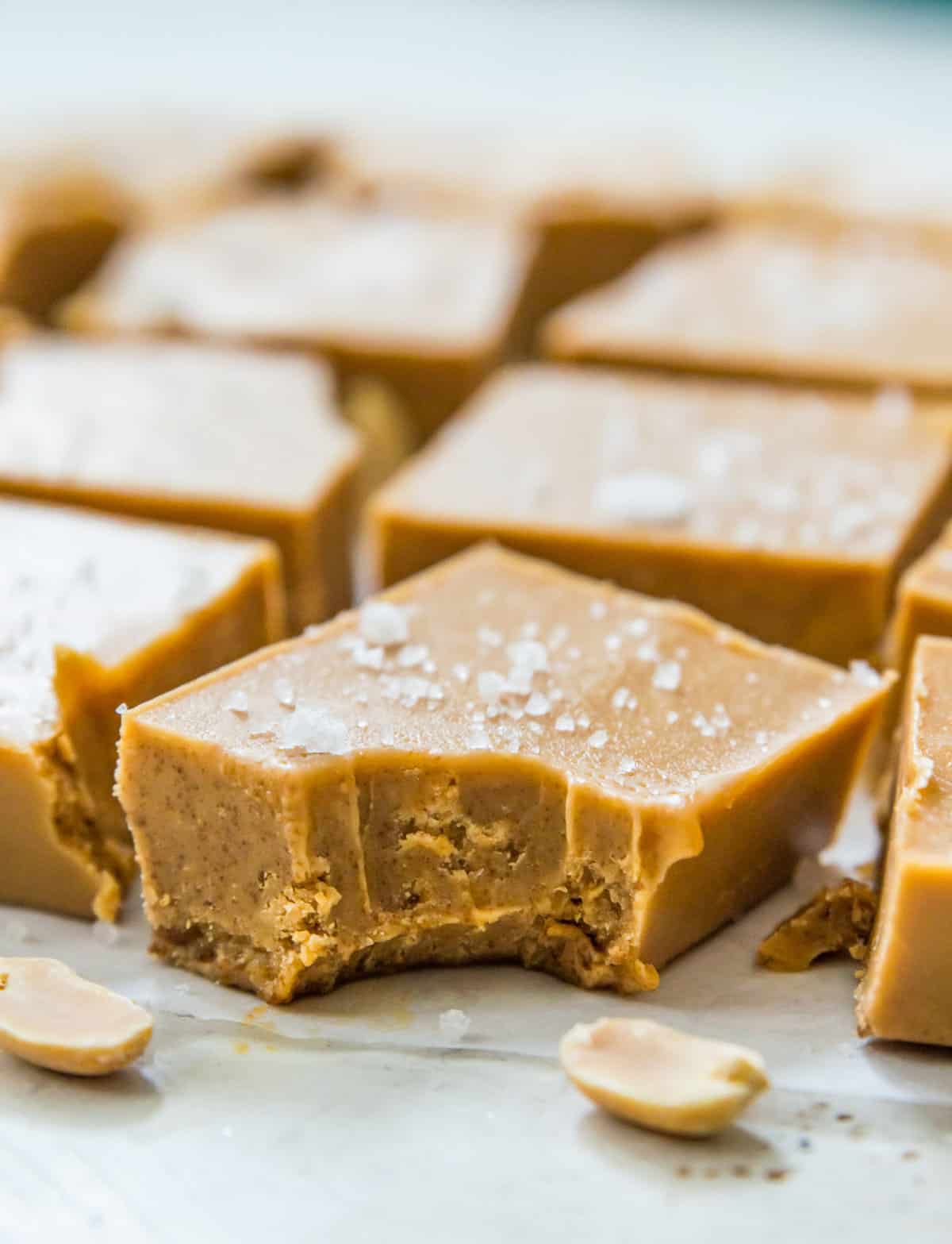 A piece of no bake peanut butter fudge with a bite out of it.