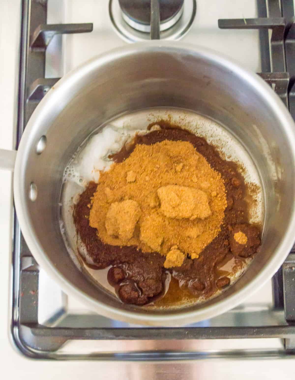 Coconut sugar and coconut oil in a pot on the stovetop.
