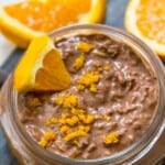 A jar of chocolate orange overnight oats garnished with orange zest.