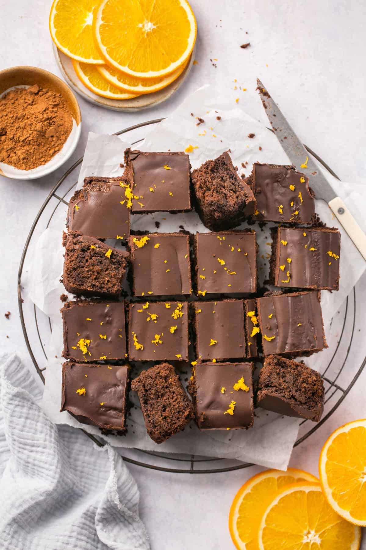 Orange chocolate brownies cut into pieces and garnished with orange zest. 
