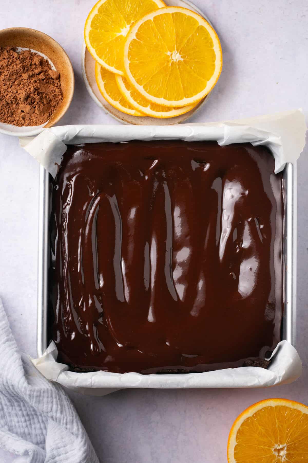 A pan of orange chocolate brownies with chocolate icing on top. 