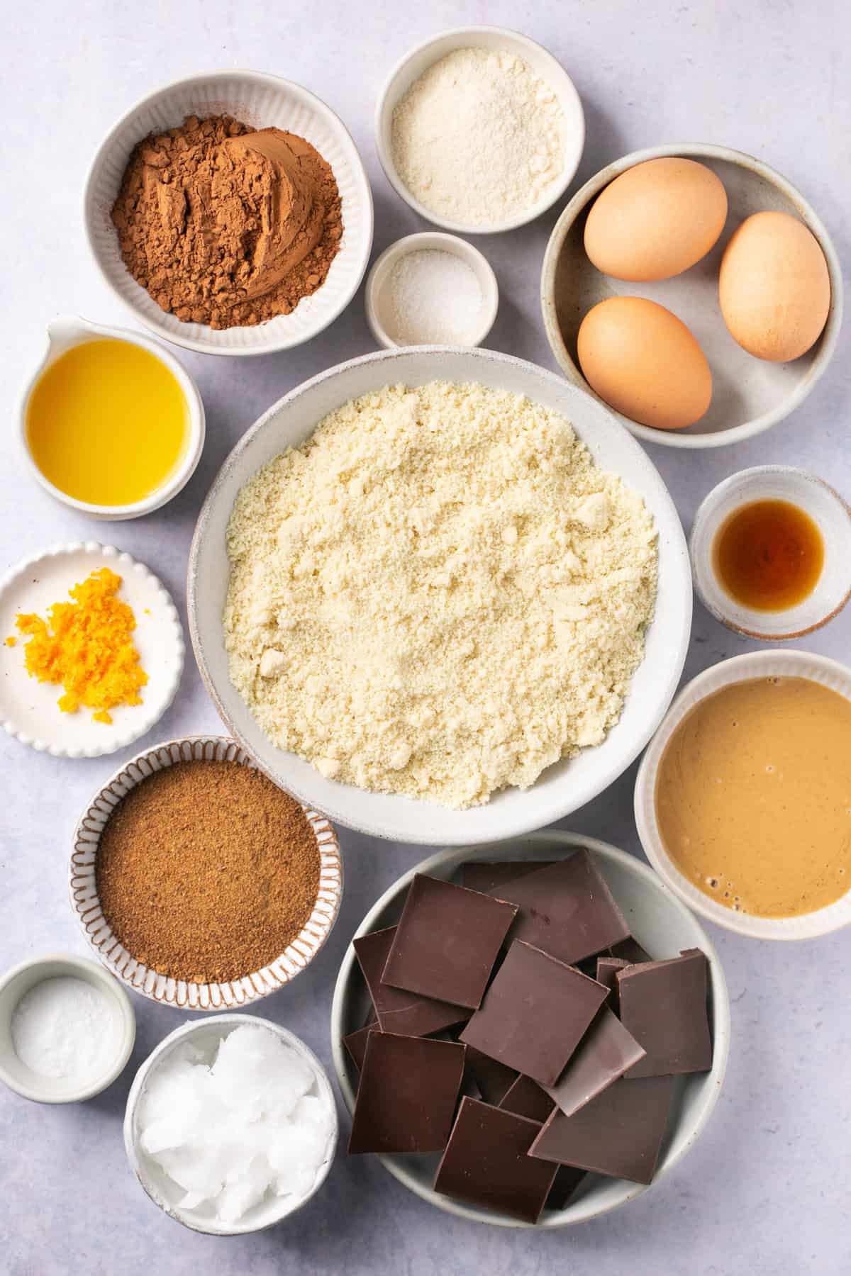 The ingredients needed to make paleo orange chocolate brownies separated into bowls. 