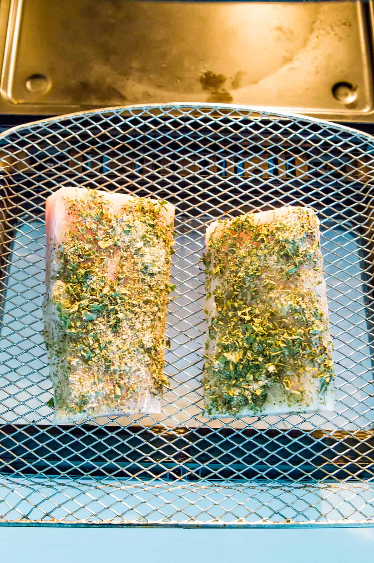 Mahi Mahi filets on an air fryer rack.