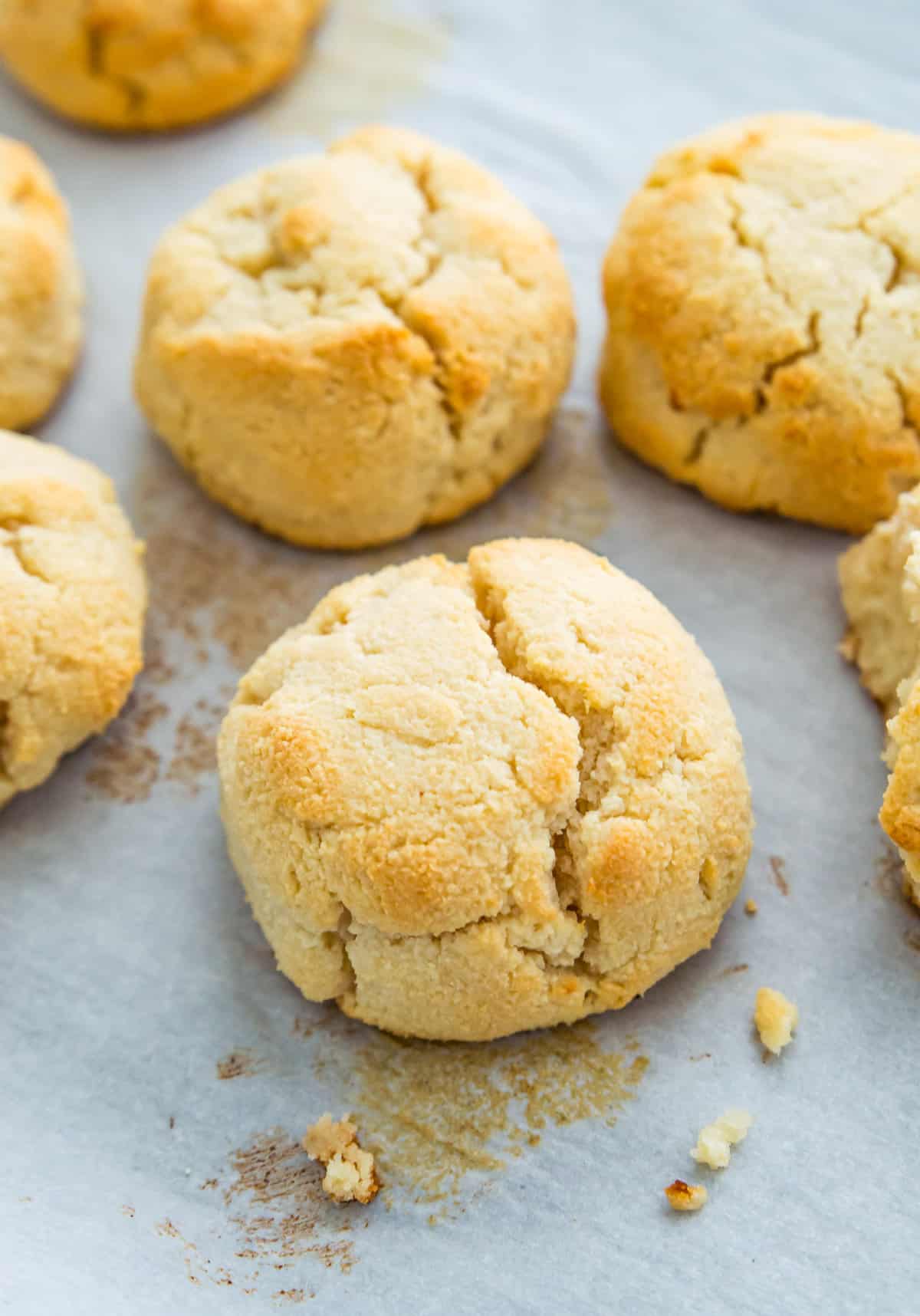 Baked biscuits on a baking sheet lined with parchment paper.