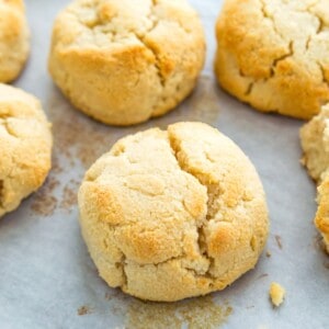 Cooked biscuits on a baking sheet lined with parchment paper.