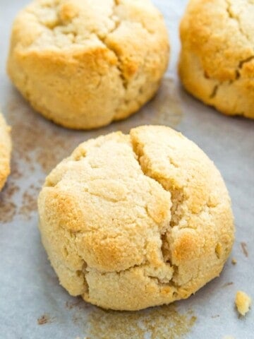 Cooked biscuits on a baking sheet lined with parchment paper.